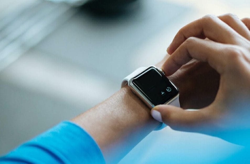 Woman logging her workout online on her watch